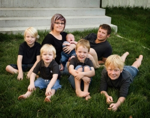 family with five kids posing for photograph on grass