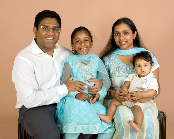 Indian family of four wearing beautiful sari for traditional family photograph