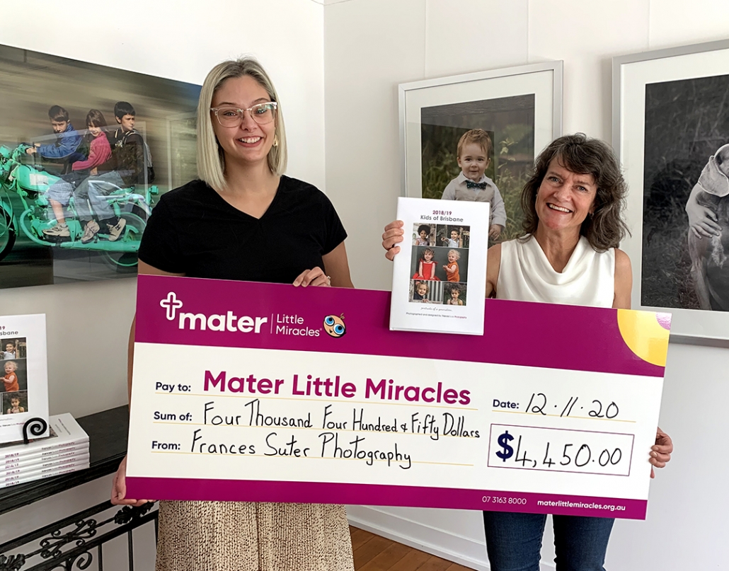 Coorparoo photographer Frances Suter holds cheque for Mater Little Miracles with Brittany from Mater Foundation in Brisbane studio