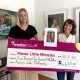 Coorparoo photographer Frances Suter holds cheque for Mater Little Miracles with Brittany from Mater Foundation in Brisbane studio