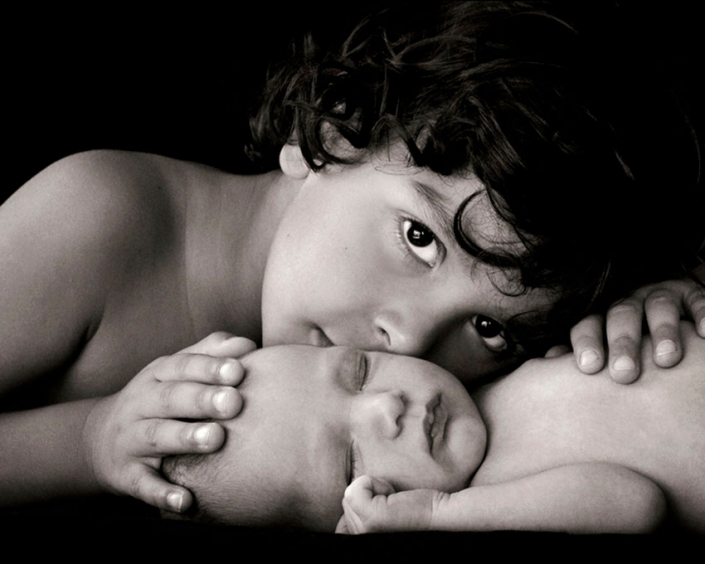 newborn baby and big brother photographed in black and white